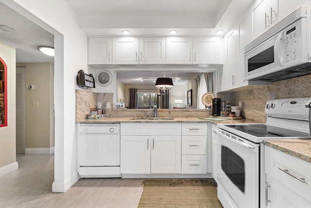 5200 E Club Cir Unit 106, Boca Raton, FL 33487 - kitchen with white appliances, a sink, decorative backsplash, and white cabinetry
