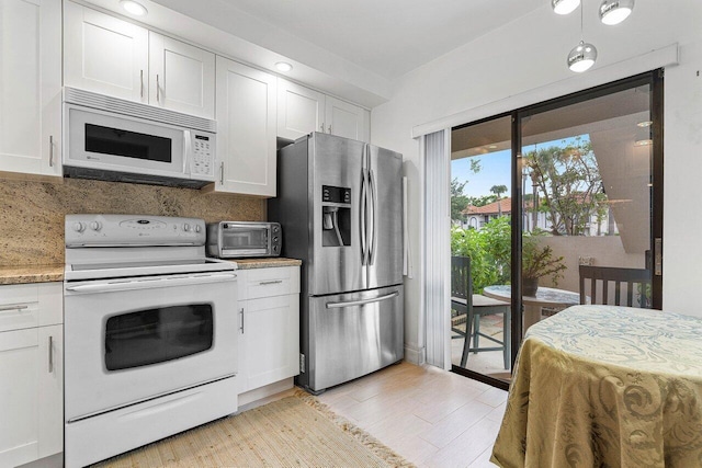 5200 E Club Cir Unit 106, Boca Raton, FL 33487 - kitchen featuring white appliances, white cabinets, backsplash, and light wood-type flooring