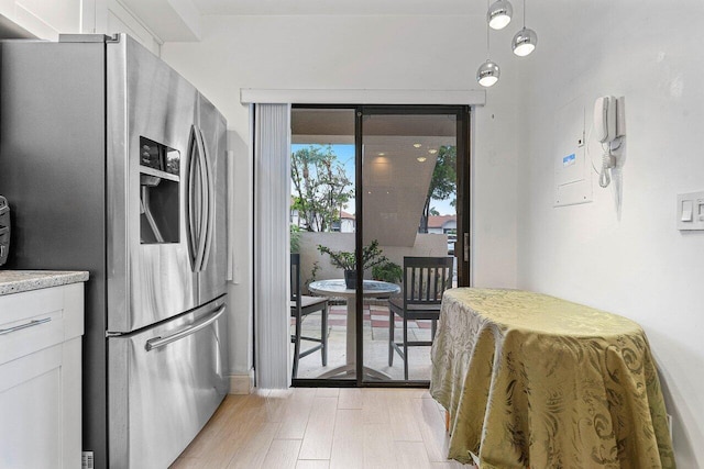 5200 E Club Cir Unit 106, Boca Raton, FL 33487 - kitchen with stainless steel fridge, light wood-type flooring, and white cabinetry
