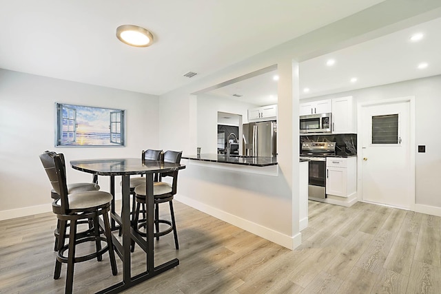2388 SW Congress Blvd, Boynton Beach, FL 33426 - dining space featuring light wood-style flooring, baseboards, and recessed lighting