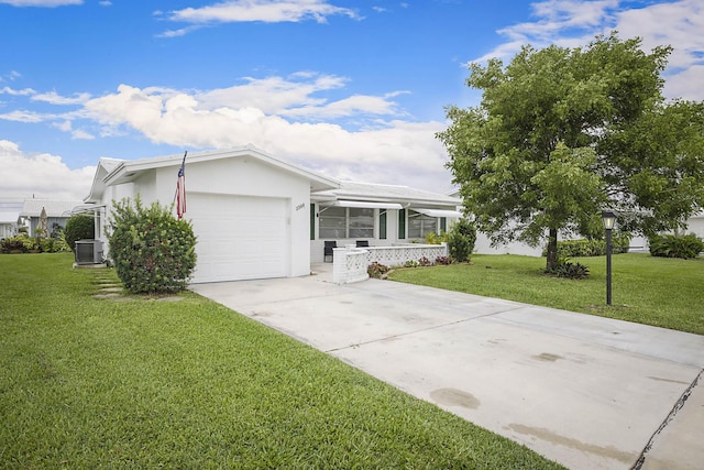 2388 SW Congress Blvd, Boynton Beach, FL 33426 - view of front of house featuring concrete driveway, a garage, a front lawn, central air condition unit, and stucco siding