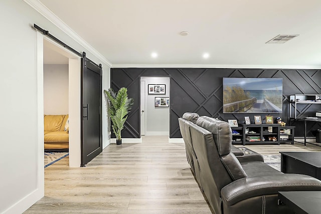 2388 SW Congress Blvd, Boynton Beach, FL 33426 - cinema with a barn door, ornamental molding, light wood-style floors, baseboards, and a decorative wall