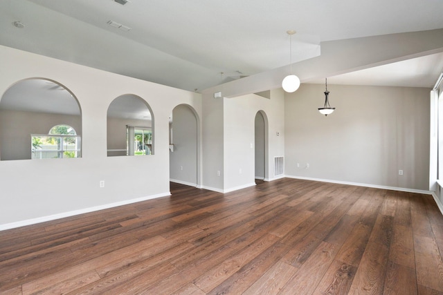 1552 SW Neponset Rd, Port Saint Lucie, FL 34953 - unfurnished room with vaulted ceiling, dark wood finished floors, arched walkways, and baseboards