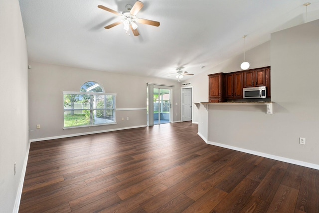 1552 SW Neponset Rd, Port Saint Lucie, FL 34953 - unfurnished living room with ceiling fan, dark wood finished floors, baseboards, and lofted ceiling