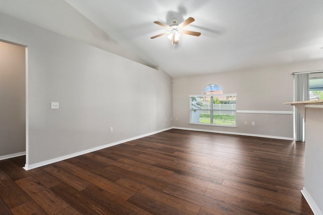 1552 SW Neponset Rd, Port Saint Lucie, FL 34953 - unfurnished living room featuring ceiling fan, dark wood-style flooring, vaulted ceiling, and baseboards