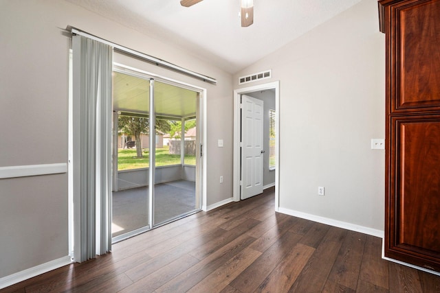 1552 SW Neponset Rd, Port Saint Lucie, FL 34953 - unfurnished room featuring vaulted ceiling, dark wood finished floors, a ceiling fan, and baseboards