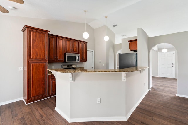 1552 SW Neponset Rd, Port Saint Lucie, FL 34953 - kitchen featuring stainless steel appliances, high vaulted ceiling, a kitchen bar, and stone counters