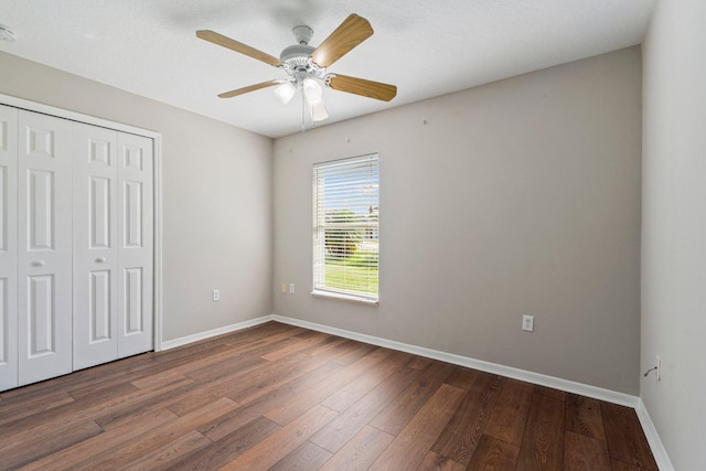 1552 SW Neponset Rd, Port Saint Lucie, FL 34953 - unfurnished bedroom featuring dark wood-style flooring, a closet, baseboards, and a ceiling fan