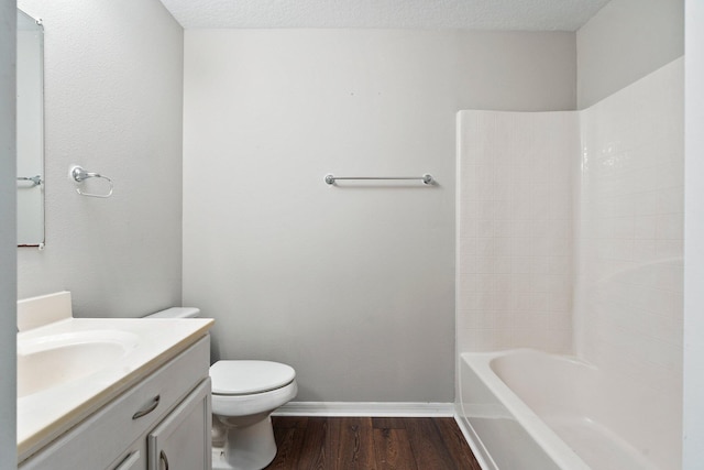 1552 SW Neponset Rd, Port Saint Lucie, FL 34953 - bathroom with toilet, vanity, wood finished floors, baseboards, and washtub / shower combination