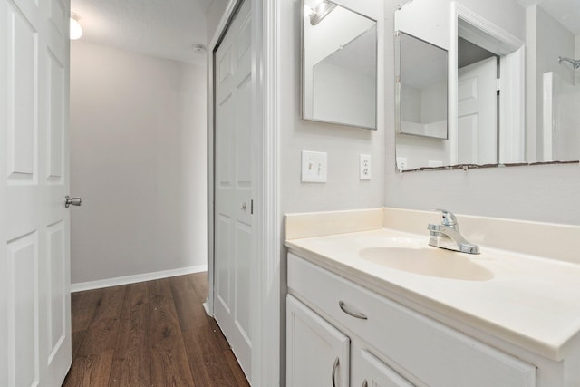1552 SW Neponset Rd, Port Saint Lucie, FL 34953 - bathroom featuring vanity, wood finished floors, and baseboards