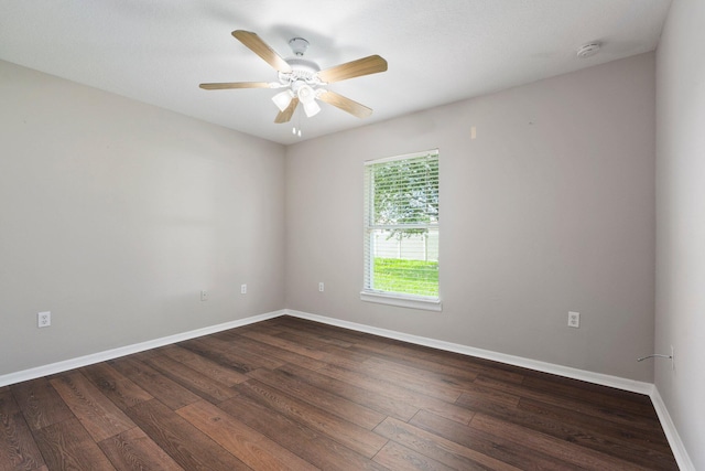 1552 SW Neponset Rd, Port Saint Lucie, FL 34953 - unfurnished room featuring dark wood-type flooring, baseboards, a ceiling fan, and a smoke detector