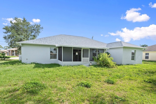 1552 SW Neponset Rd, Port Saint Lucie, FL 34953 - rear view of property with a sunroom, a shingled roof, stucco siding, and a lawn