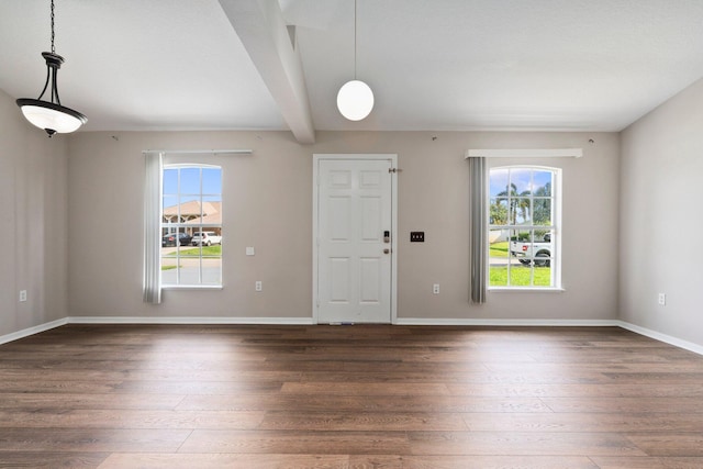1552 SW Neponset Rd, Port Saint Lucie, FL 34953 - entryway with wood finished floors, healthy amount of natural light, beam ceiling, and baseboards
