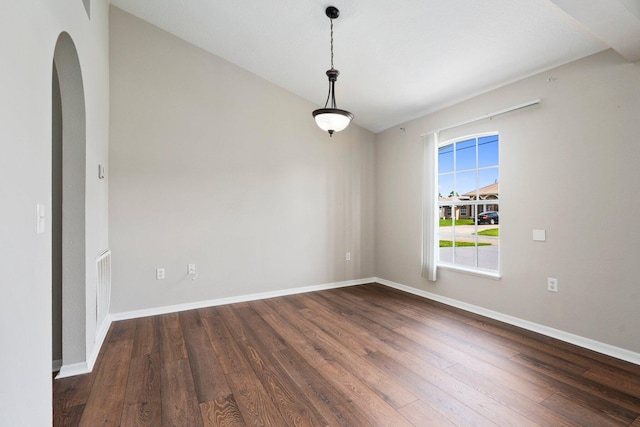 1552 SW Neponset Rd, Port Saint Lucie, FL 34953 - empty room with dark wood-style floors, baseboards, and arched walkways