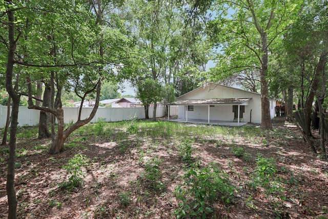1803 NE 29th Pl, Ocala, FL 34479 - fenced backyard featuring a patio area