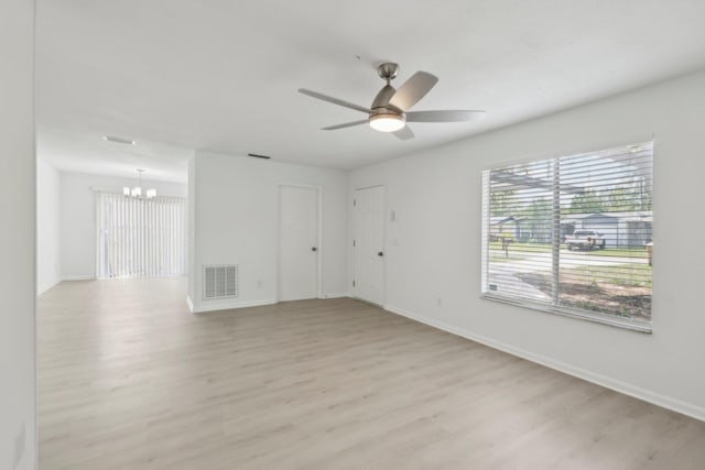 1803 NE 29th Pl, Ocala, FL 34479 - unfurnished room with a chandelier, light wood-style flooring, baseboards, and ceiling fan