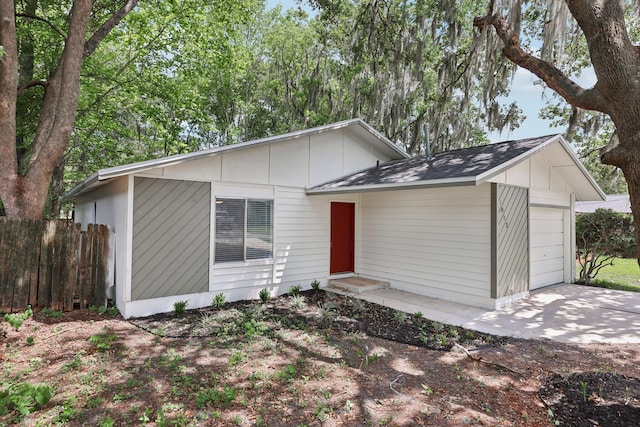 1803 NE 29th Pl, Ocala, FL 34479 - mid-century inspired home featuring an attached garage, concrete driveway, and roof with shingles