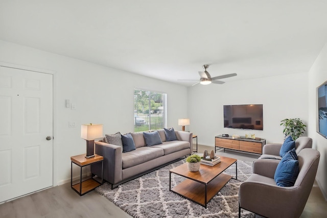 1803 NE 29th Pl, Ocala, FL 34479 - living room with light wood-style floors, a ceiling fan, and baseboards