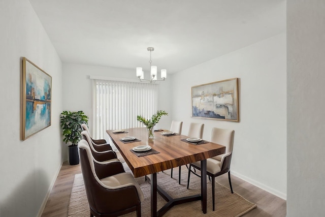 1803 NE 29th Pl, Ocala, FL 34479 - dining room with a chandelier, wood finished floors, and baseboards