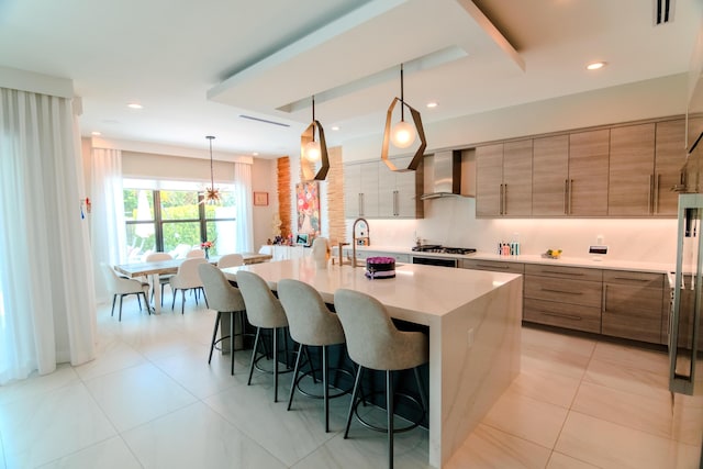 8305 Fishhawk Falls Ct, Boca Raton, FL 33496 - kitchen with wall chimney exhaust hood, a kitchen breakfast bar, a sink, light countertops, and an island with sink