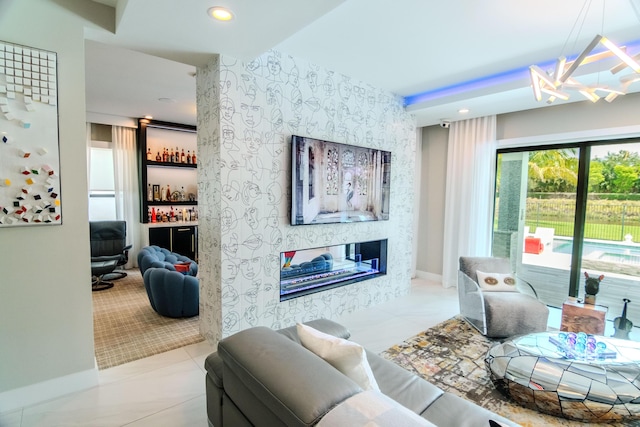 8305 Fishhawk Falls Ct, Boca Raton, FL 33496 - living area with a chandelier, an accent wall, a multi sided fireplace, wallpapered walls, and recessed lighting