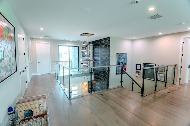 8305 Fishhawk Falls Ct, Boca Raton, FL 33496 - hallway with an upstairs landing, wood finished floors, and recessed lighting