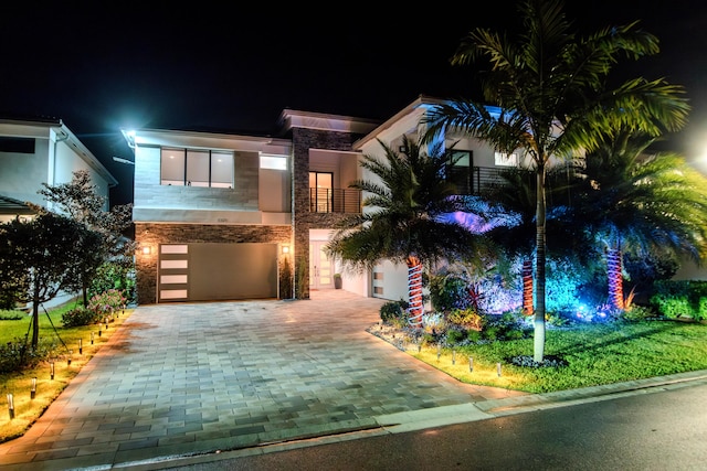 8305 Fishhawk Falls Ct, Boca Raton, FL 33496 - modern home featuring decorative driveway, a garage, stone siding, and a balcony