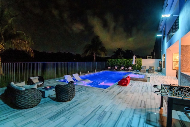 8305 Fishhawk Falls Ct, Boca Raton, FL 33496 - pool at twilight featuring an outdoor fire pit, a patio, and a fenced backyard