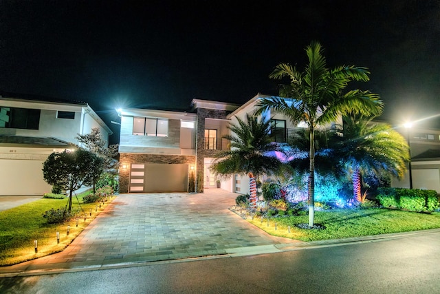 8305 Fishhawk Falls Ct, Boca Raton, FL 33496 - contemporary home featuring stone siding, decorative driveway, and an attached garage