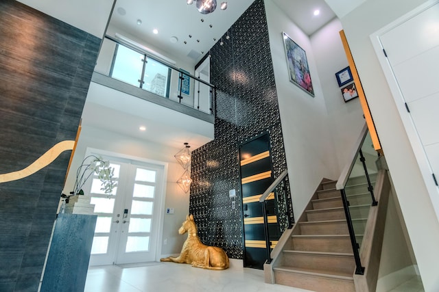 8305 Fishhawk Falls Ct, Boca Raton, FL 33496 - staircase featuring a high ceiling, french doors, healthy amount of natural light, recessed lighting, and a chandelier