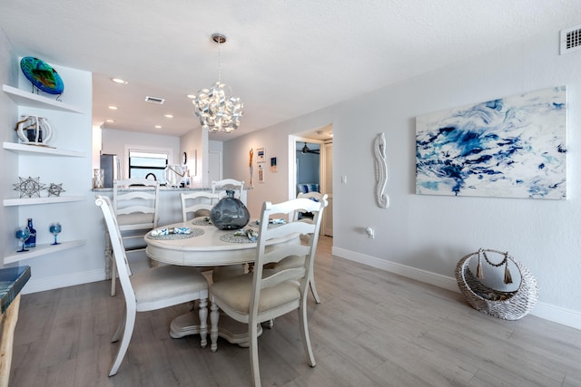 7430 S Ocean Dr Unit 518, Jensen Beach, FL 34957 - dining area with a chandelier, light wood-type flooring, and baseboards