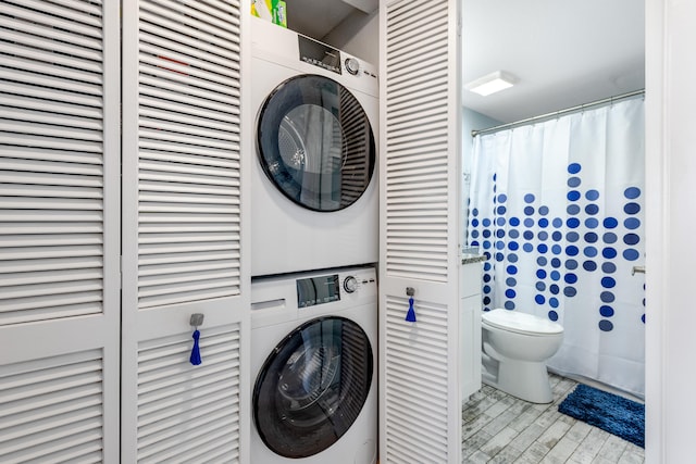 7430 S Ocean Dr Unit 518, Jensen Beach, FL 34957 - laundry room with stacked washer and clothes dryer and wood finished floors