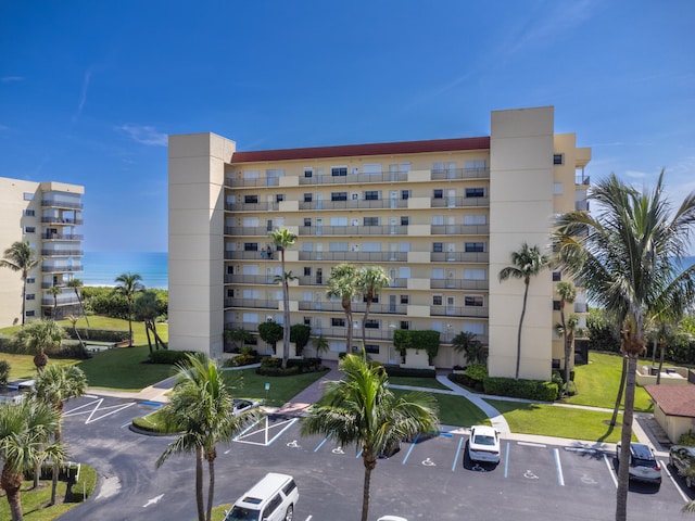 7430 S Ocean Dr Unit 518, Jensen Beach, FL 34957 - view of apartment building / complex featuring uncovered parking and a water view