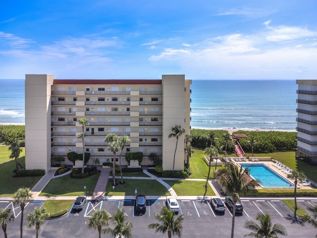 7430 S Ocean Dr Unit 518, Jensen Beach, FL 34957 - view of building exterior featuring uncovered parking and a water view