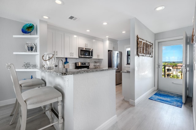 7430 S Ocean Dr Unit 518, Jensen Beach, FL 34957 - kitchen with appliances with stainless steel finishes, open shelves, baseboards, backsplash, and recessed lighting