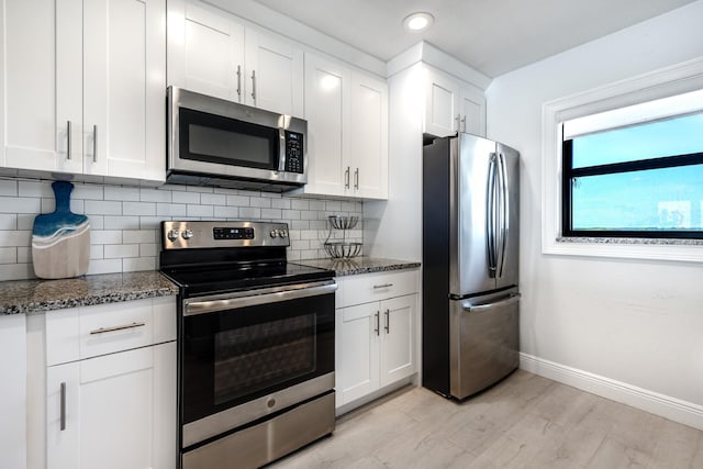 7430 S Ocean Dr Unit 518, Jensen Beach, FL 34957 - kitchen featuring appliances with stainless steel finishes, dark stone counters, baseboards, tasteful backsplash, and recessed lighting