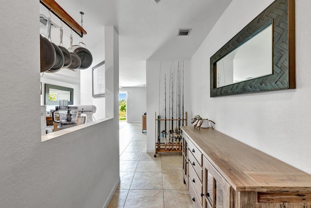 5285 SE Jennings Ln, Stuart, FL 34997 - hallway with a textured wall and light tile patterned flooring