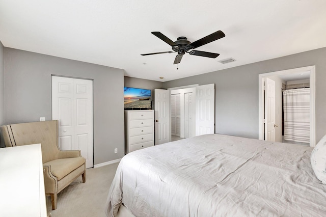 5285 SE Jennings Ln, Stuart, FL 34997 - bedroom with light colored carpet, two closets, baseboards, and ceiling fan
