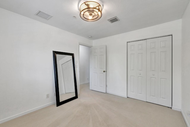 5285 SE Jennings Ln, Stuart, FL 34997 - unfurnished bedroom featuring light carpet, baseboards, and a closet