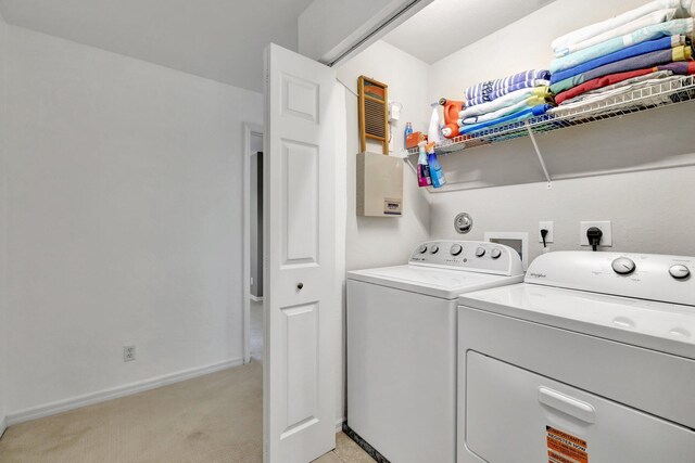 5285 SE Jennings Ln, Stuart, FL 34997 - laundry area with washing machine and clothes dryer, light colored carpet, and baseboards