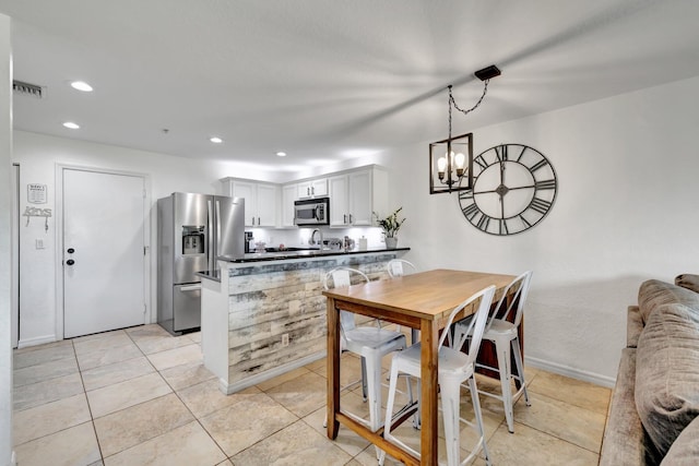5285 SE Jennings Ln, Stuart, FL 34997 - dining room with recessed lighting, a chandelier, and light tile patterned floors
