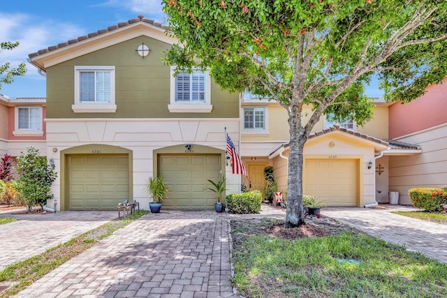 5285 SE Jennings Ln, Stuart, FL 34997 - view of property with stucco siding, driveway, and an attached garage