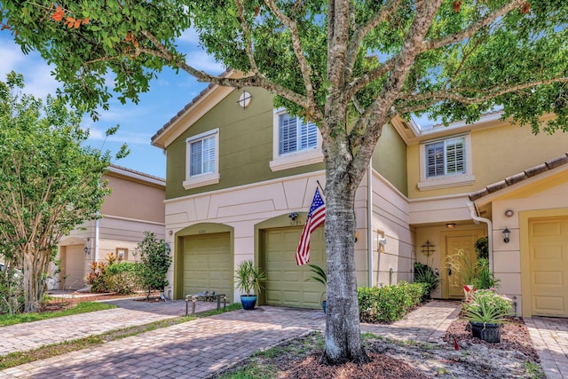 5285 SE Jennings Ln, Stuart, FL 34997 - view of property with a garage, stucco siding, and driveway
