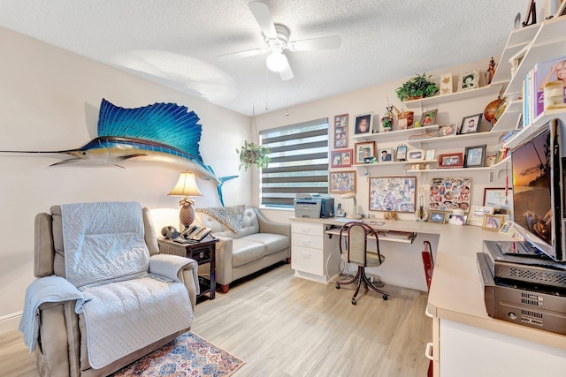 4101 Coral Tree Cir Unit 116, Coconut Creek, FL 33073 - office area with a ceiling fan, a textured ceiling, built in study area, and light wood-style flooring