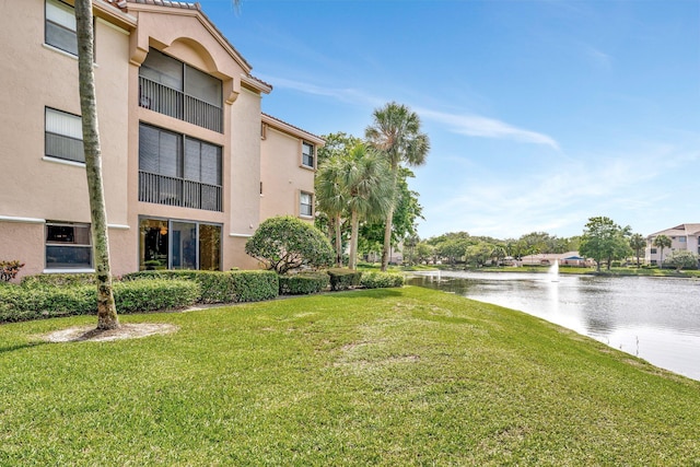 4101 Coral Tree Cir Unit 116, Coconut Creek, FL 33073 - surrounding community with a water view and a lawn
