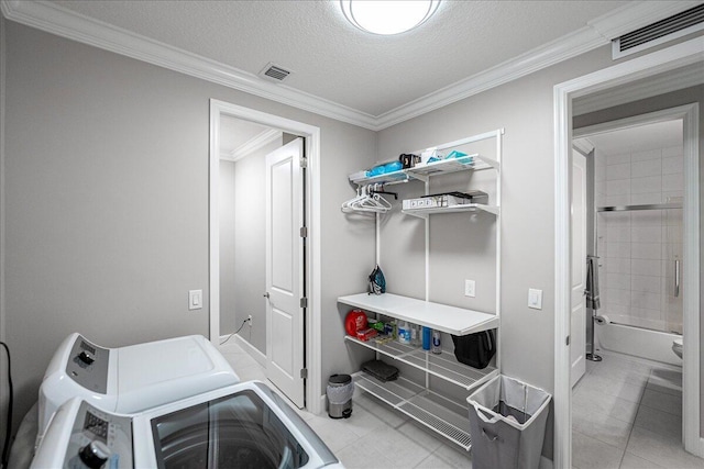 11688 SW Brighton Falls Dr, Port Saint Lucie, FL 34987 - laundry room with washer and dryer, ornamental molding, light tile patterned floors, and a textured ceiling