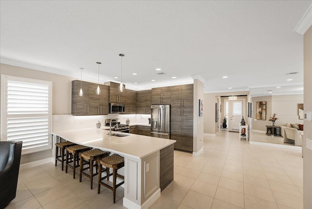 11688 SW Brighton Falls Dr, Port Saint Lucie, FL 34987 - kitchen featuring appliances with stainless steel finishes, a sink, a kitchen bar, a peninsula, and crown molding