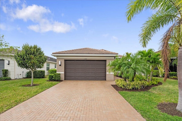 11688 SW Brighton Falls Dr, Port Saint Lucie, FL 34987 - view of front of property with decorative driveway, a front yard, stucco siding, and a garage