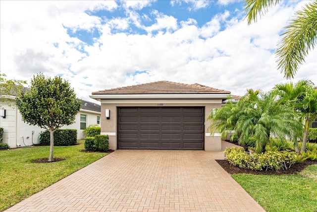 11688 SW Brighton Falls Dr, Port Saint Lucie, FL 34987 - view of front of home with decorative driveway, stucco siding, an attached garage, and a front yard