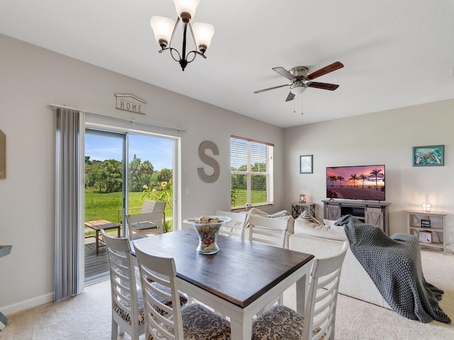 2536 Creekside Dr, Fort Pierce, FL 34981 - dining area with light colored carpet, ceiling fan, a chandelier, and baseboards
